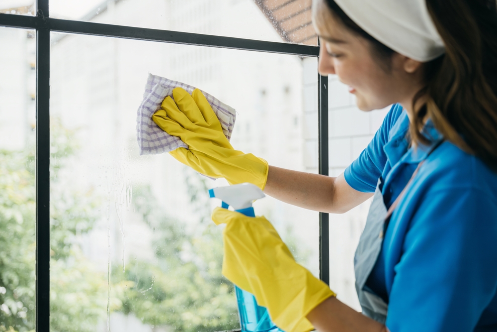 In,An,Office,Setting,A,Happy,Maid,Uses,A,Spray